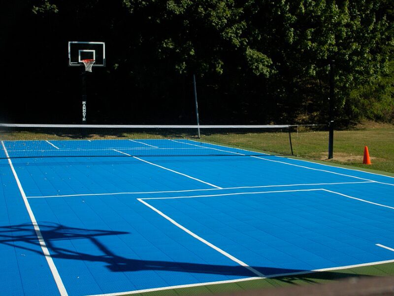 A tennis court with blue and white lines