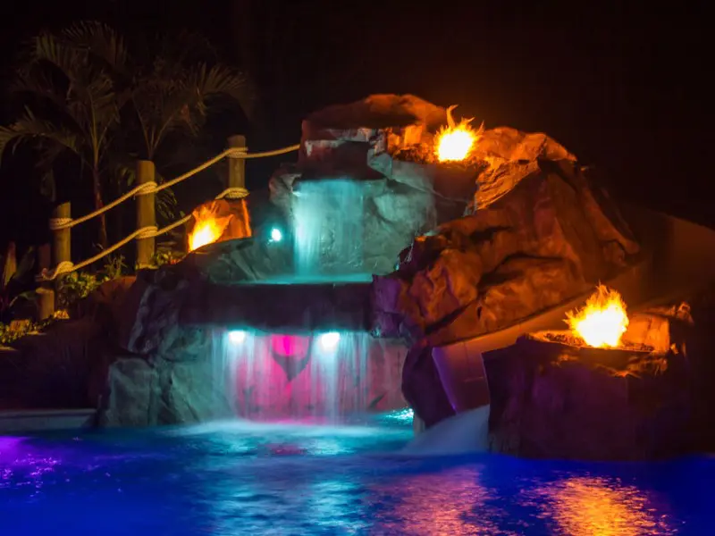 A pool with lights and rocks in the water