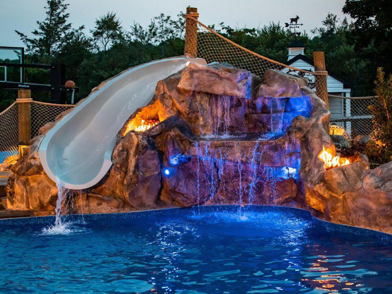 A pool with a slide and water falls