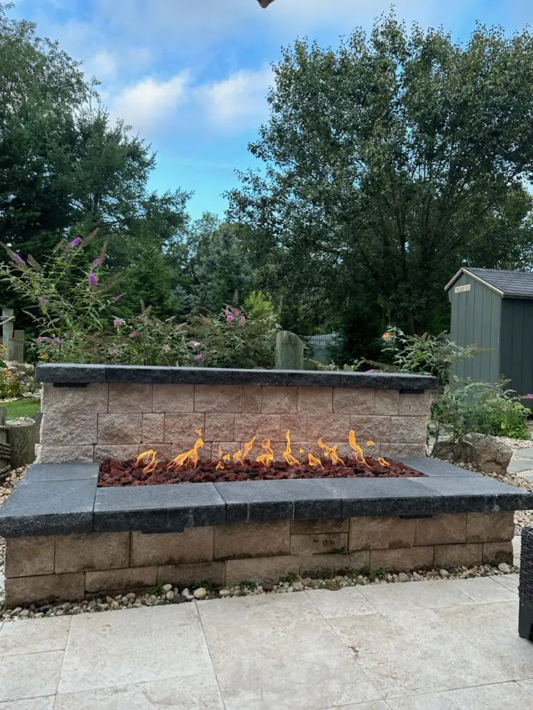 A fire pit with rocks and flames on it
