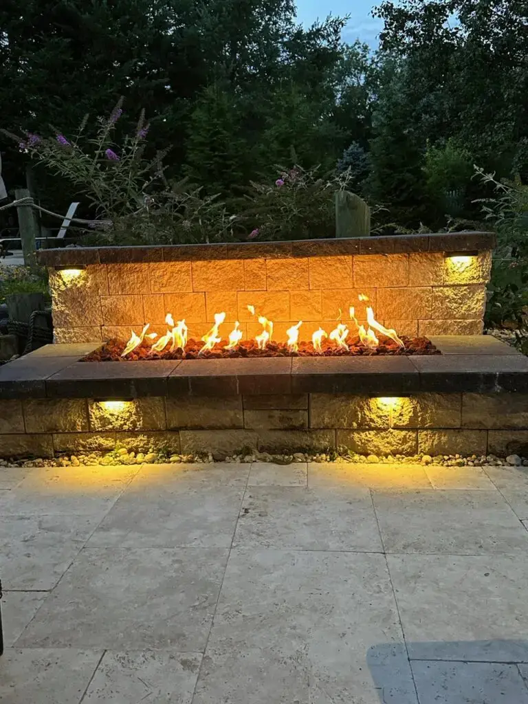 A fire pit with lights on the side of it