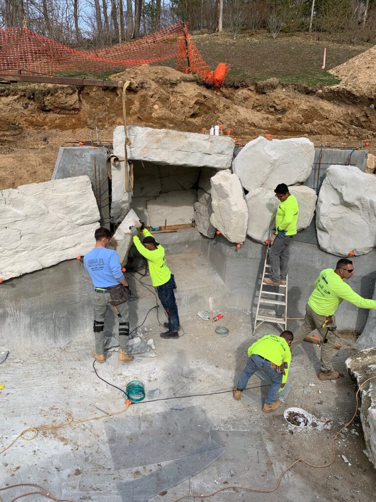 A group of men working on a stone structure.