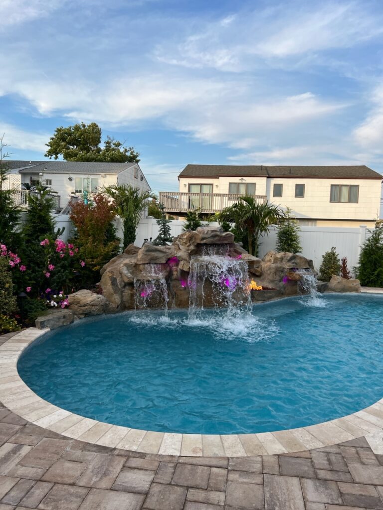 A pool with water falling from the top of it.