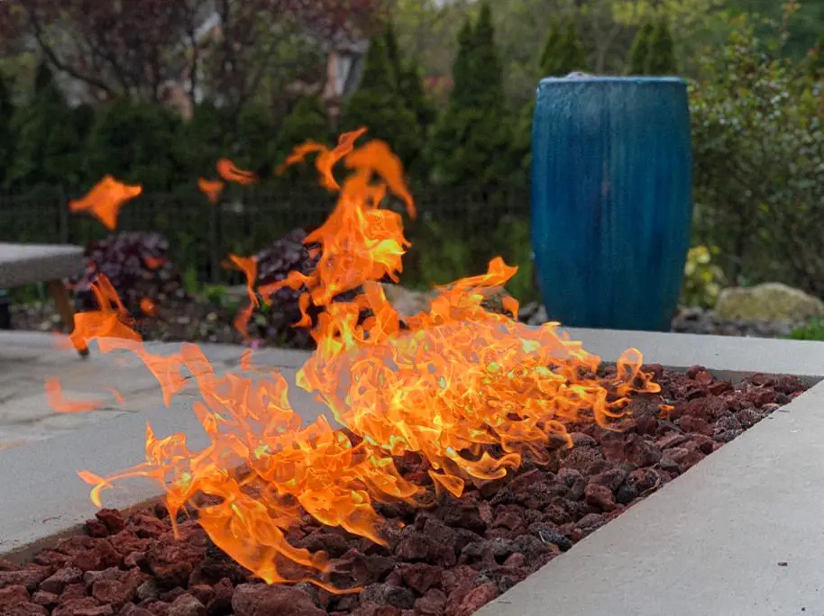 A fire pit with flames burning in it.