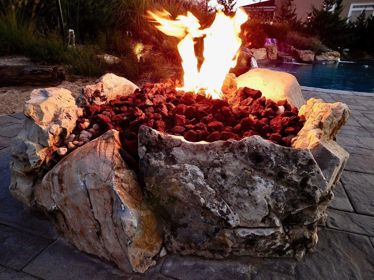 A fire pit with rocks and flames in it.