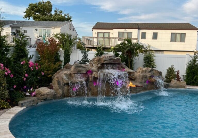A pool with water falling from the top of it.