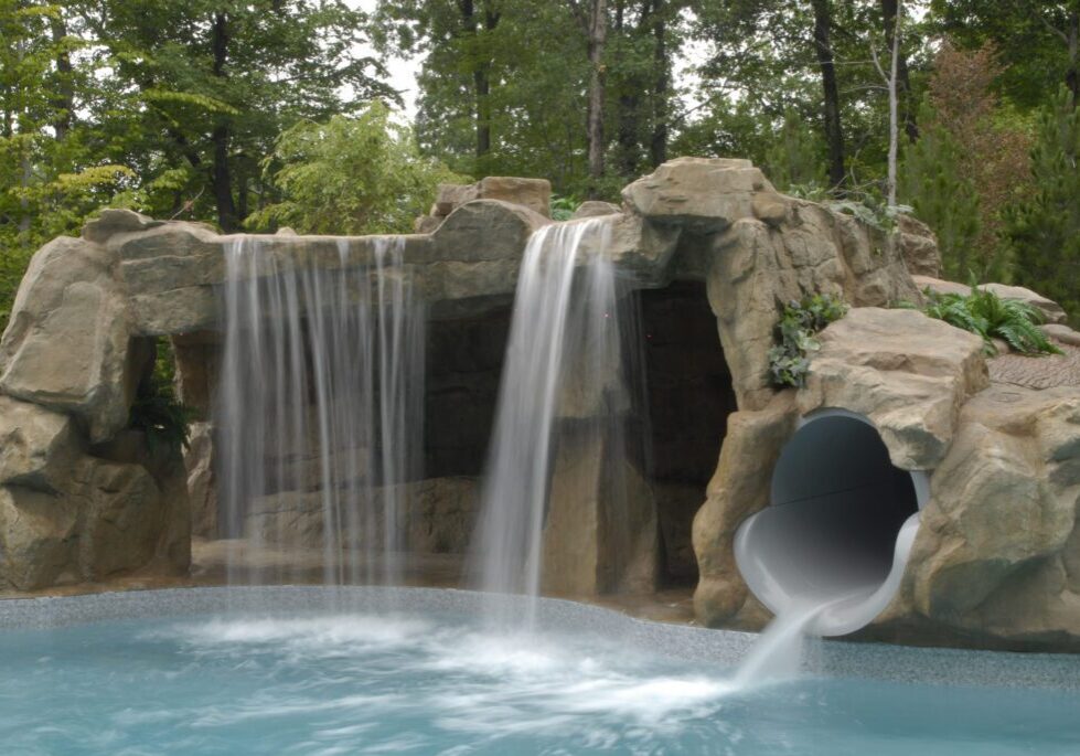A pool with water flowing from the bottom of it.
